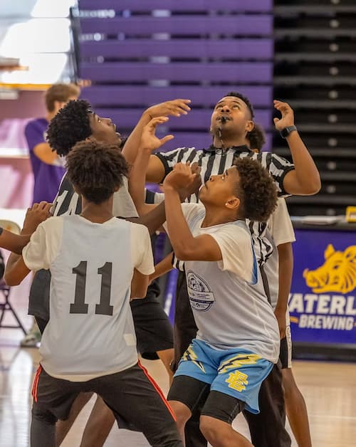 A group of kids playing basketball