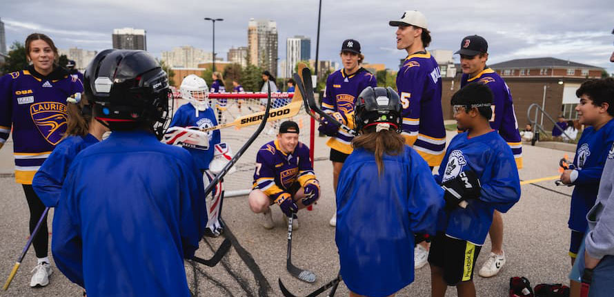 A group of camp participants playing hockey